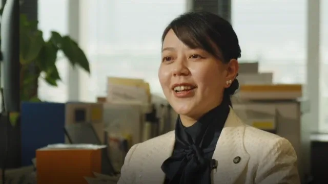 Shoko Kawata con camisa negra y chaqueta color crema en una entrevista con BBC